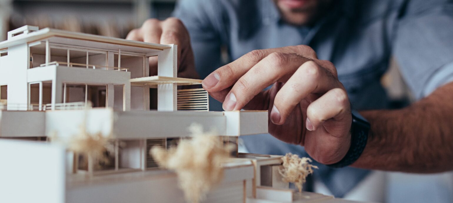 Male Architect Hands Making Model House